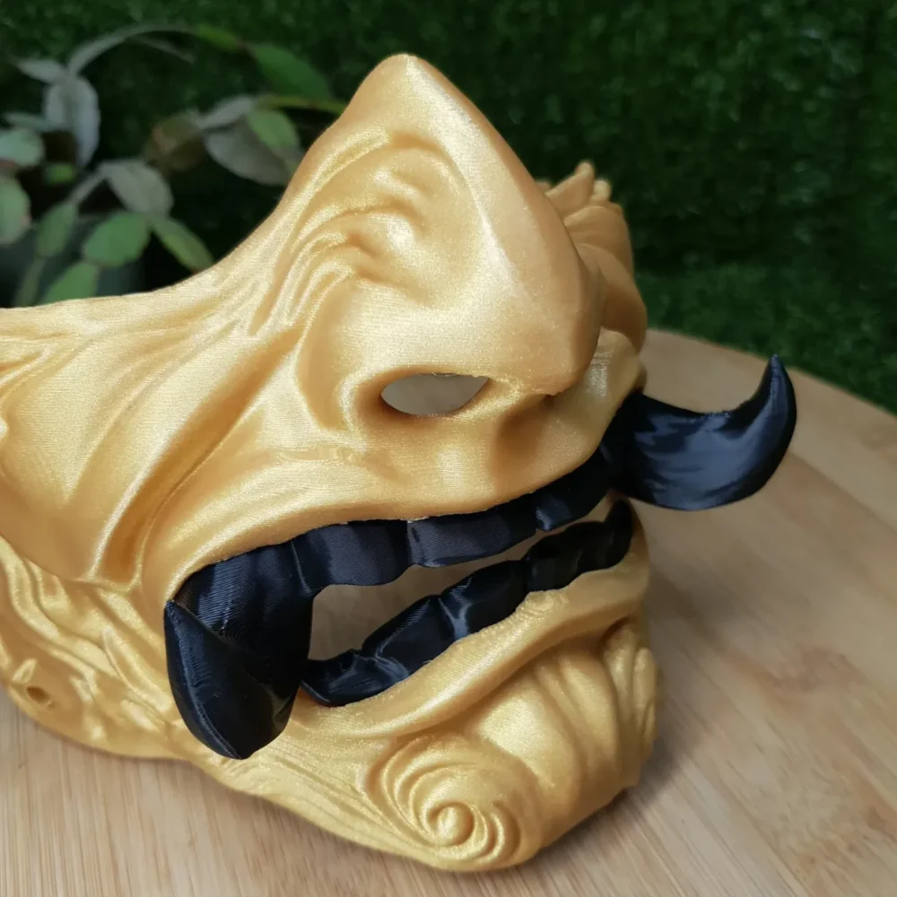 Elevate your style with this wearable 3D printed Japanese Oni mask, made from durable black and gold ABS for a bold,