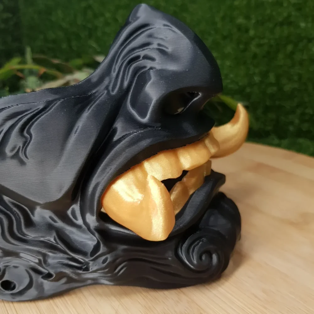 Elevate your style with this wearable 3D printed Japanese Oni mask, made from durable black and gold ABS for a bold,