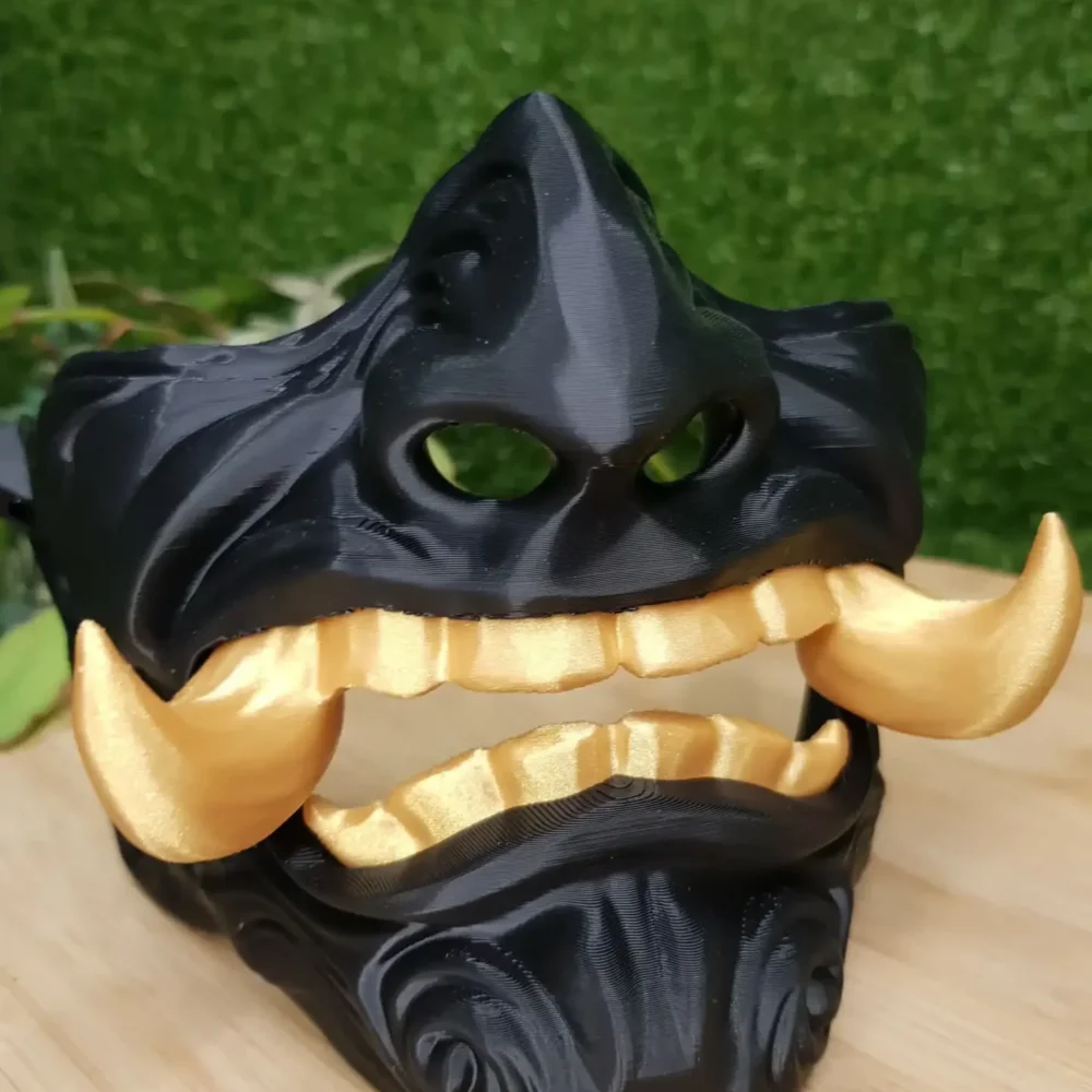 Elevate your style with this wearable 3D printed Japanese Oni mask, made from durable black and gold ABS for a bold,