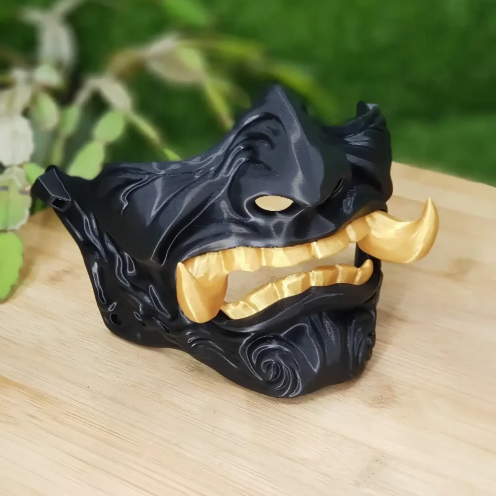 Elevate your style with this wearable 3D printed Japanese Oni mask, made from durable black and gold ABS for a bold,